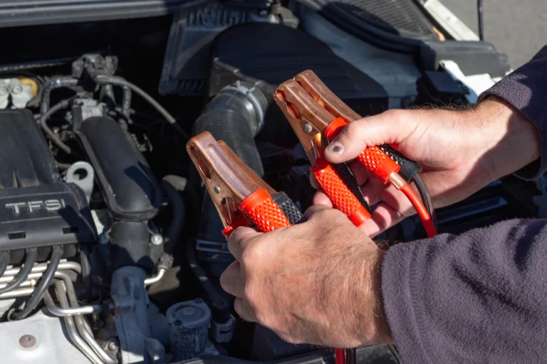 Jumper cables clamped to a car battery during a battery jump-start service